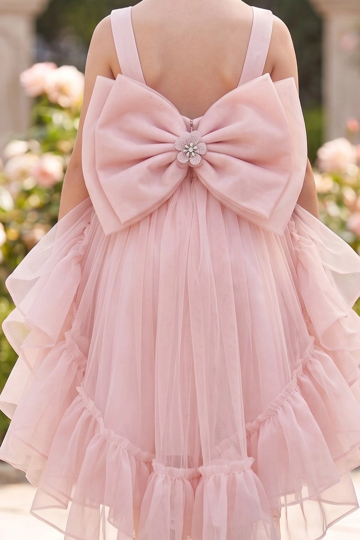 Featuring large back bow with a jeweled center on the Blush flower girl dress.