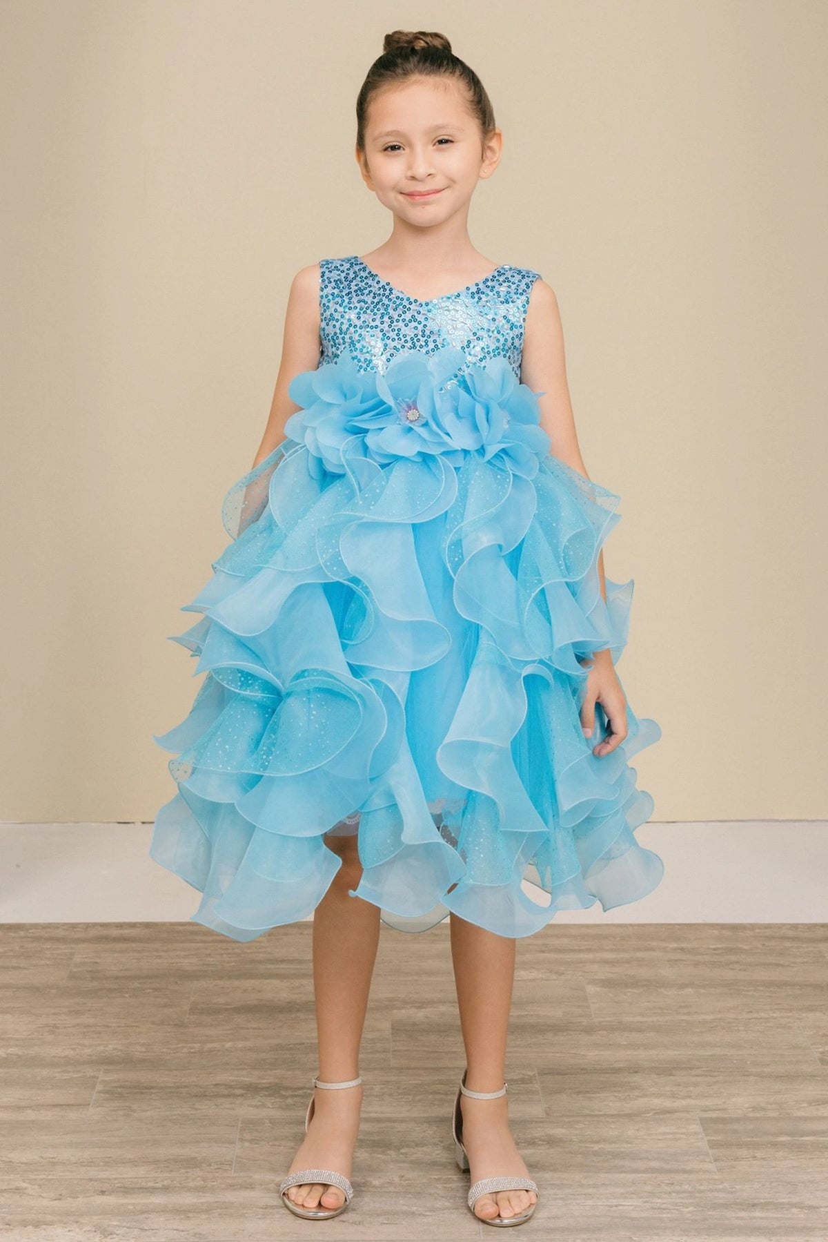 Showcasing with petal-shaped skirt ruffles, this Blue kids party dress displays elegant detail.