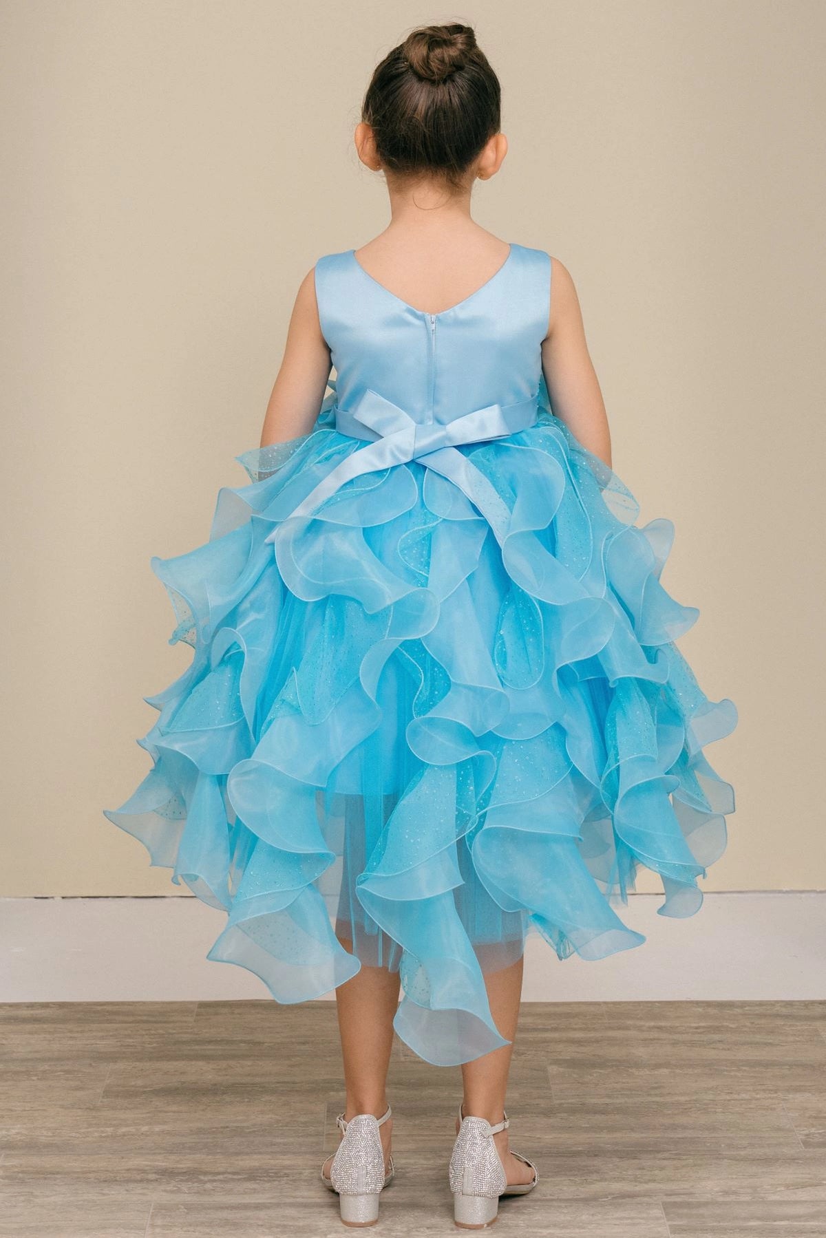 Finished details of a bow above petal-shaped ruffles distinguish the Blue kids party dress.