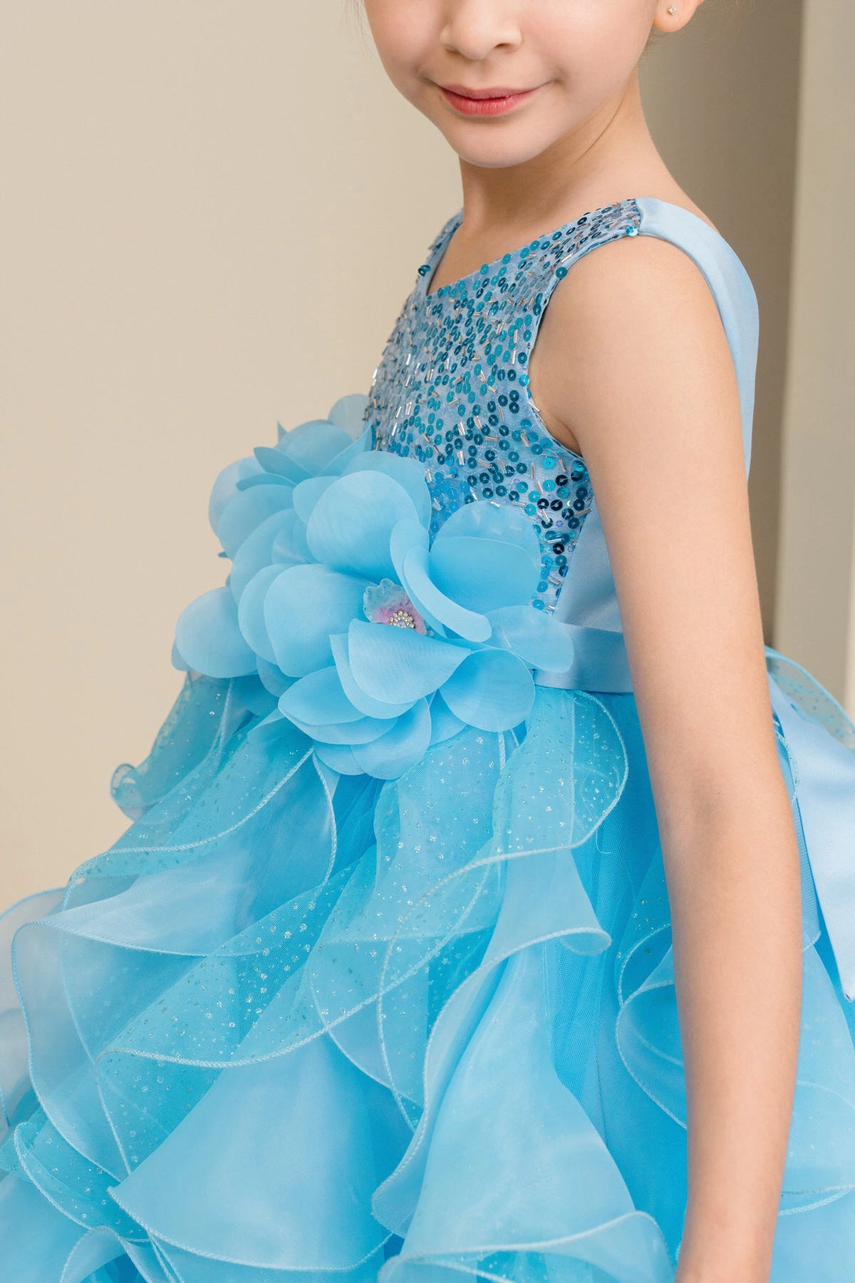 Accented petal-shaped skirt ruffles adds character to this Blue kids party dress.