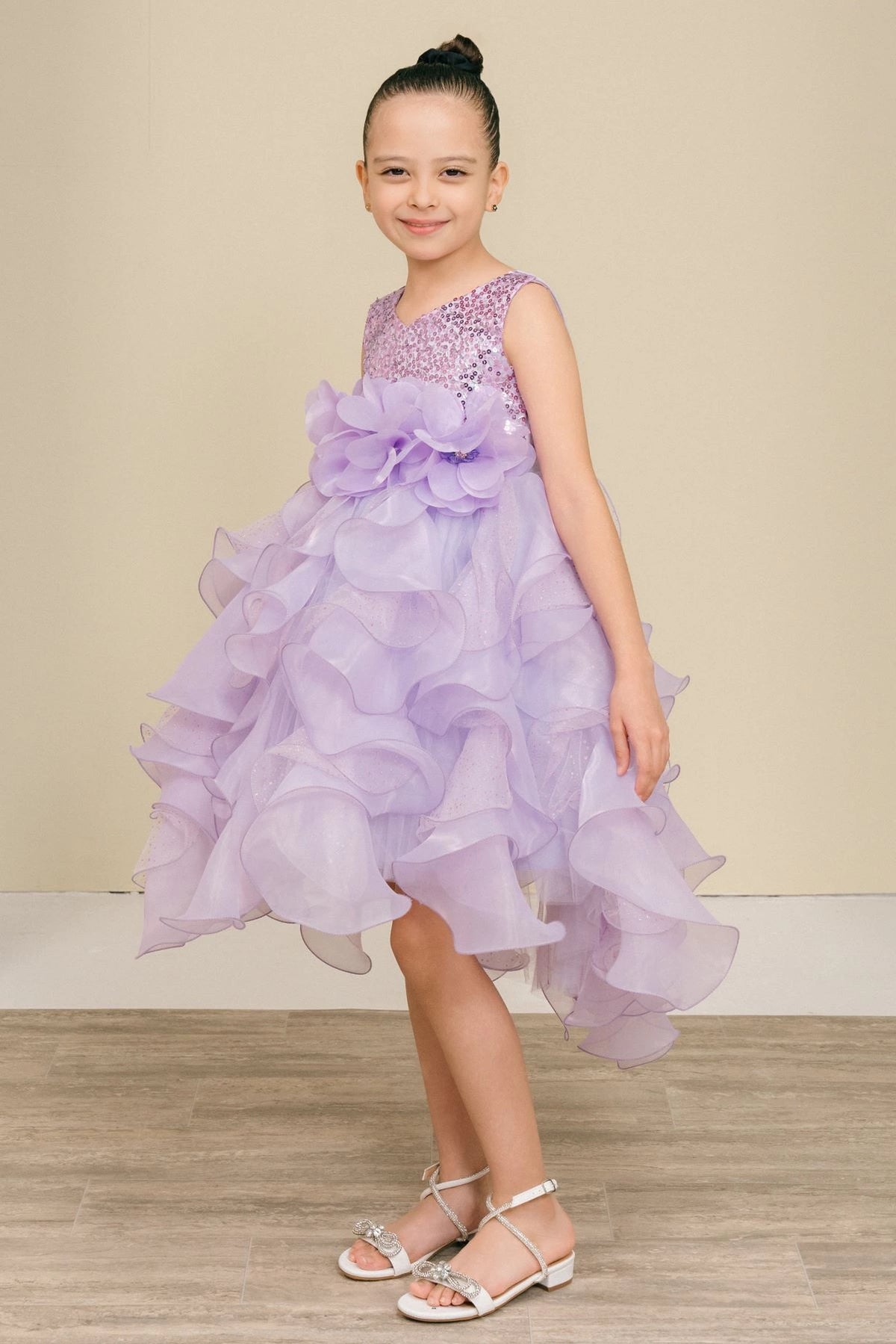 Featuring with petal-shaped skirt ruffles, this Lilac kids party dress displays elegant detail.