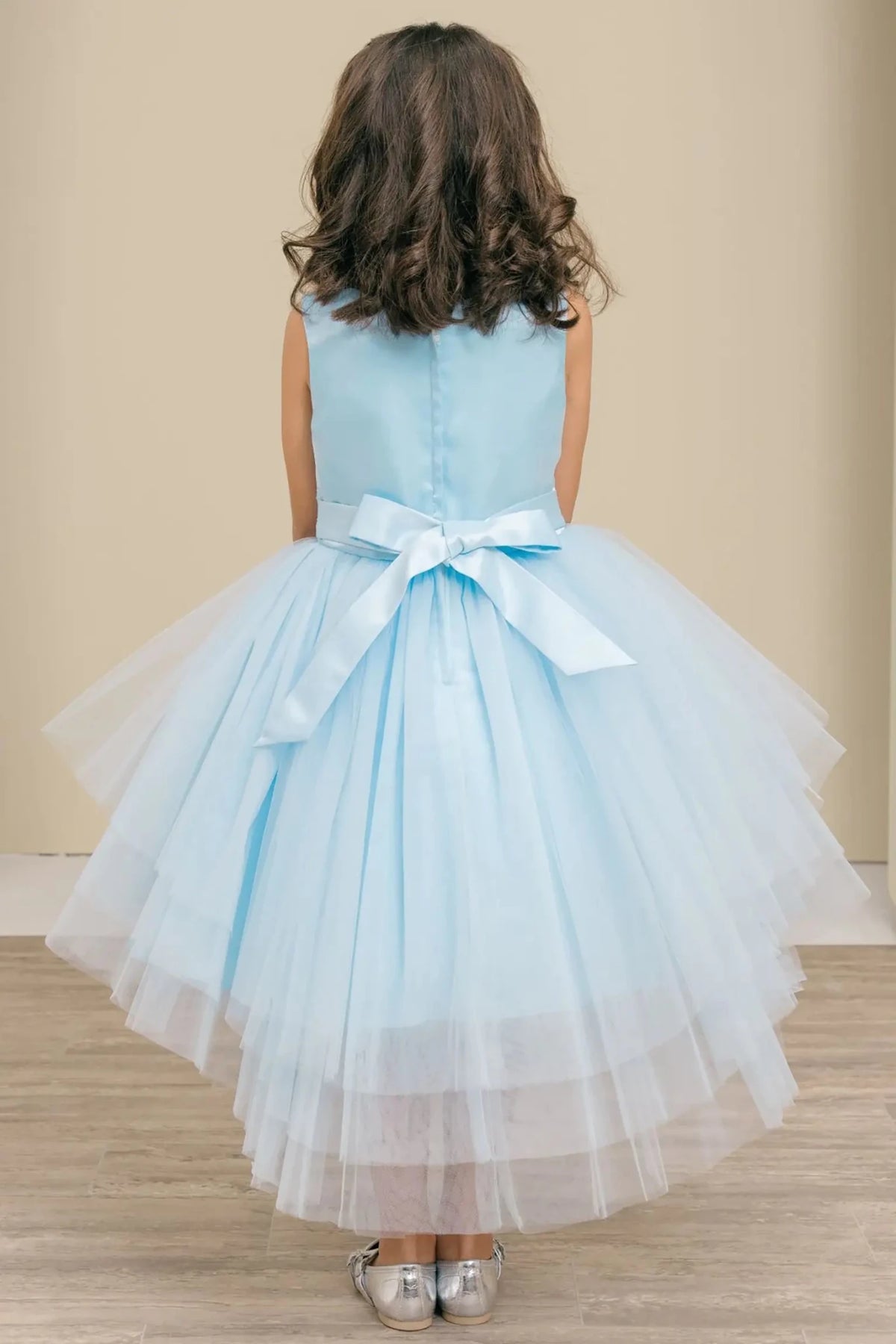 Ligh blue flower girl dress with layered glitter tulle fabric and satin bow accent.