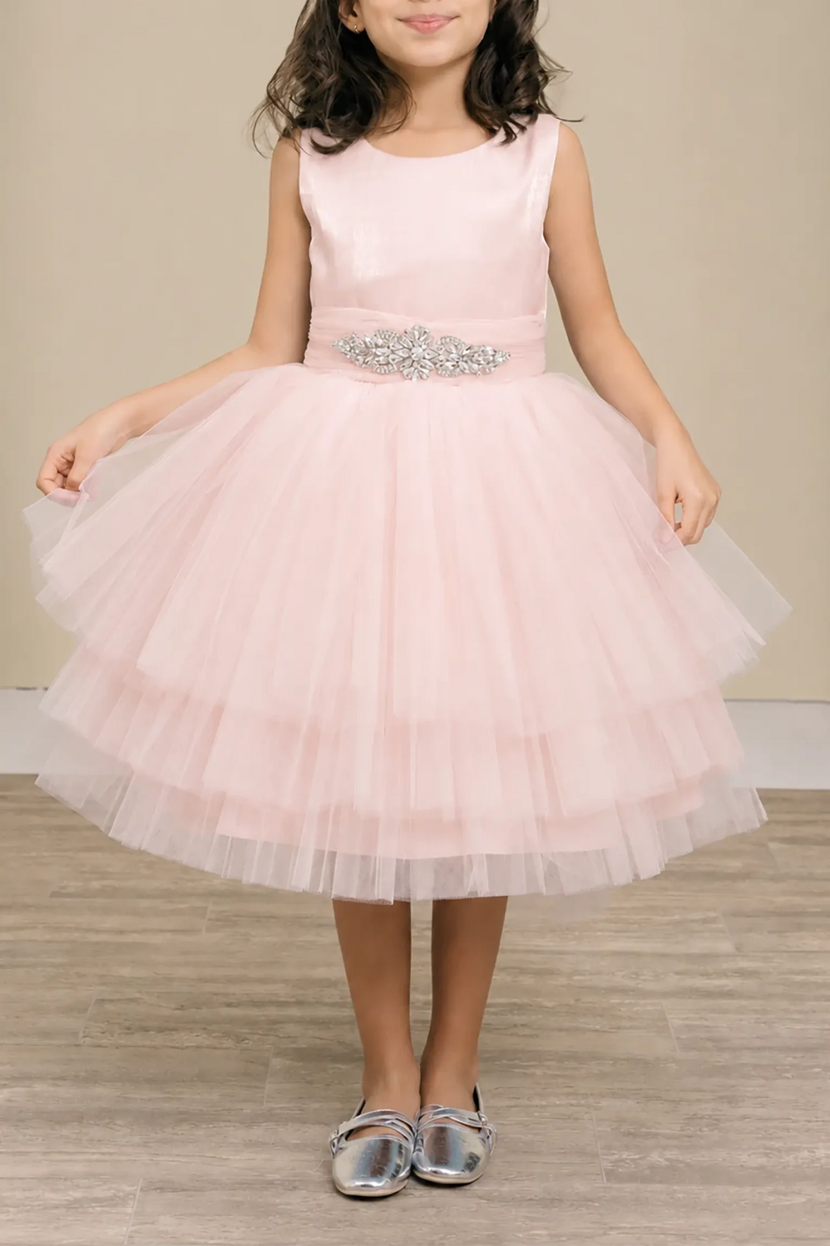 Blush flower girl dress with satin bodice, rhinestone waistband, and layered glitter tulle skirt.