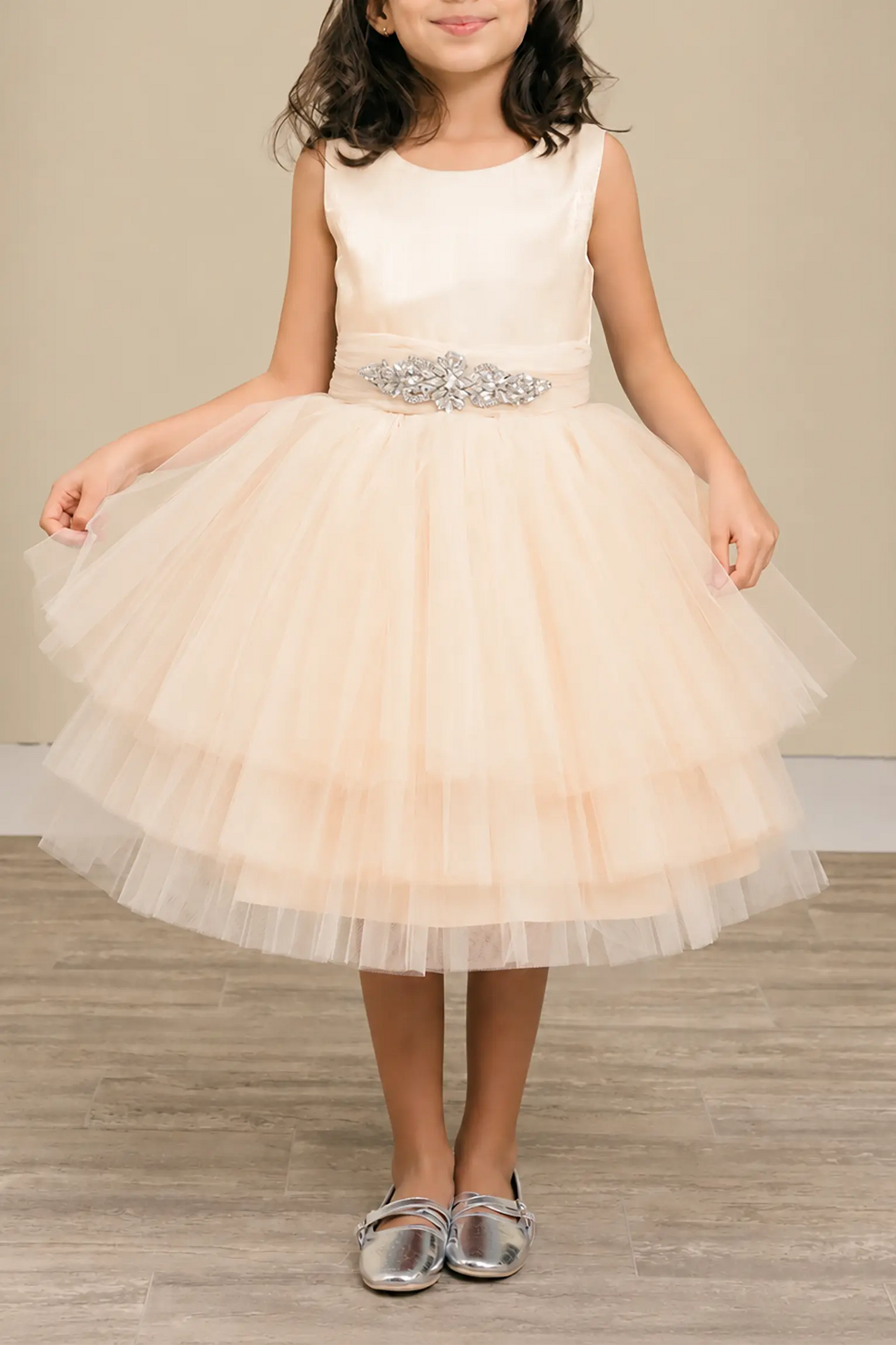Champagne flower girl dress with satin bodice, rhinestone waistband, and layered glitter tulle skirt