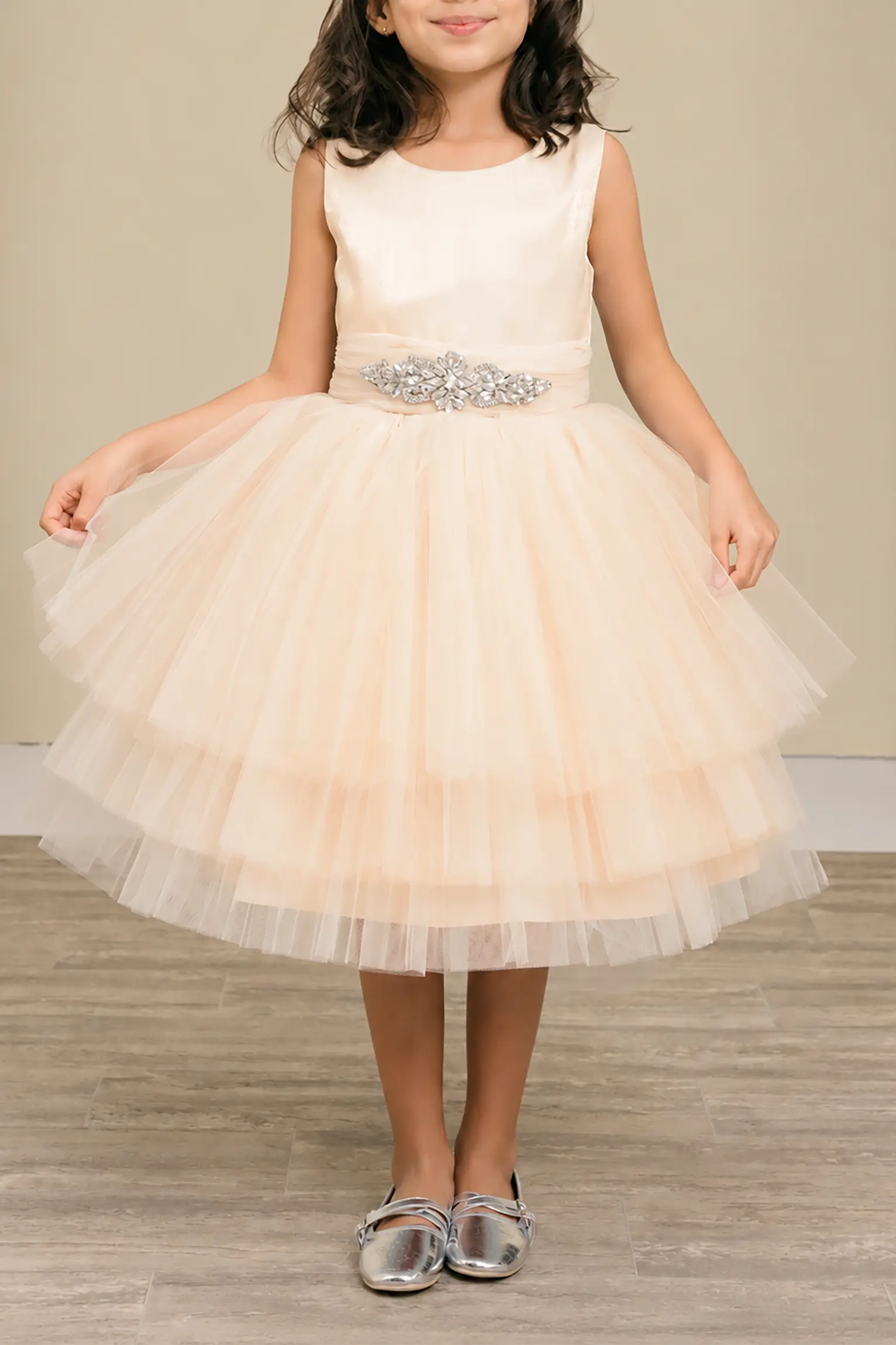 Champagne flower girl dress with satin bodice, rhinestone waistband, and layered glitter tulle skirt