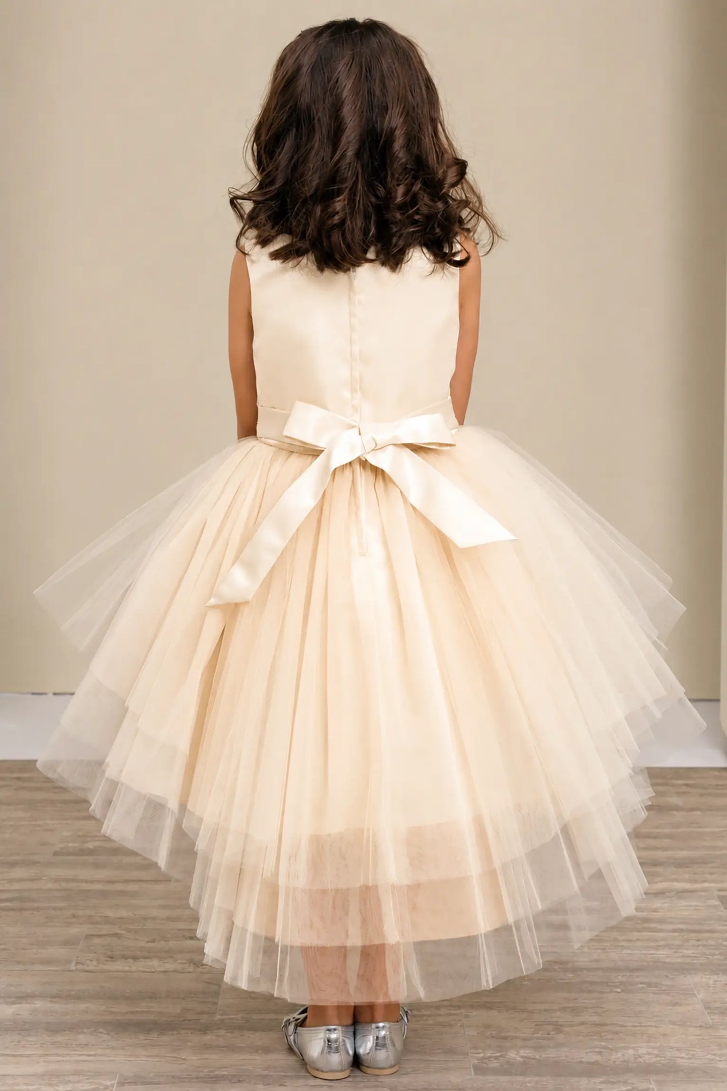Champagne flower girl dress with satin bodice, satin bow back, and layered tulle skirt