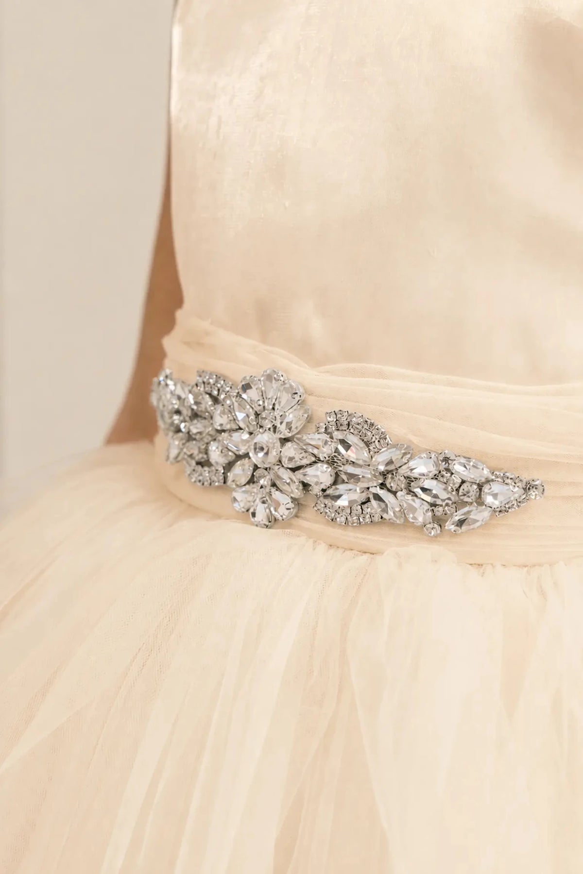 Champagne flower girl dress with rhinestone waistband, satin bodice, and glitter tulle skirt.
