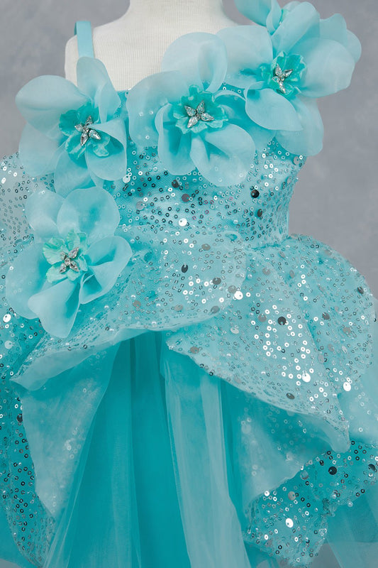 Close-up front view of blue dress showing shimmering fabric and bow accent