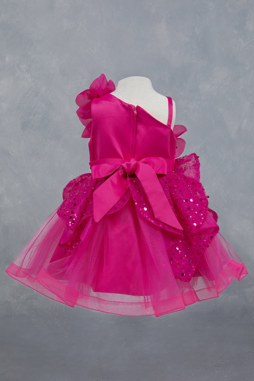 Fuchsia dress back view highlighting full skirt and elegant silhouette