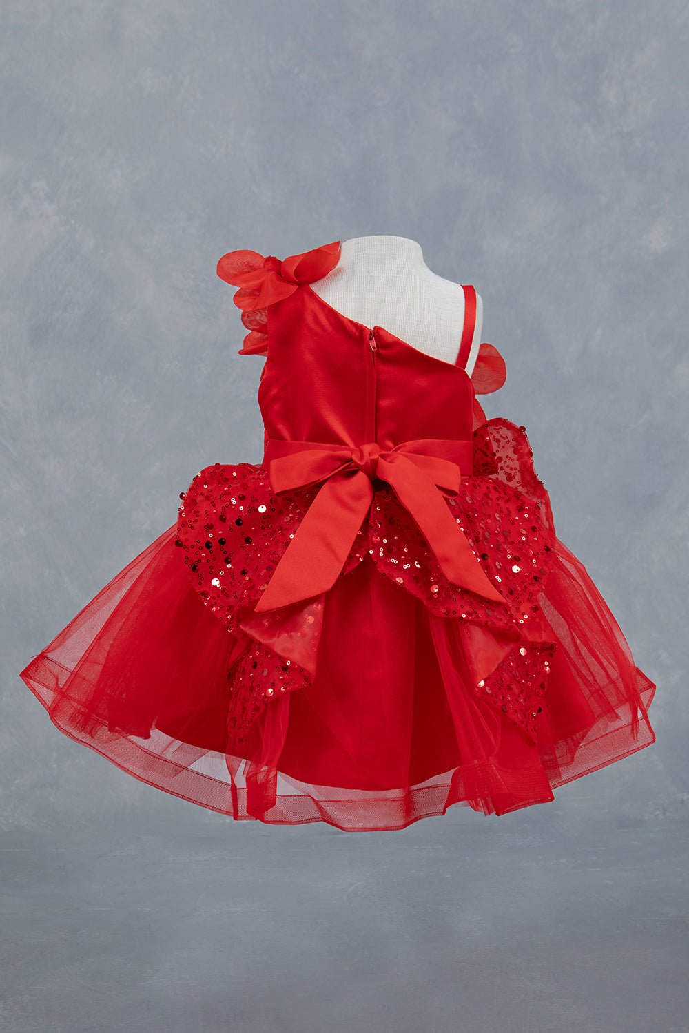 Red dress back view highlighting layered ruffles and elegant silhouette