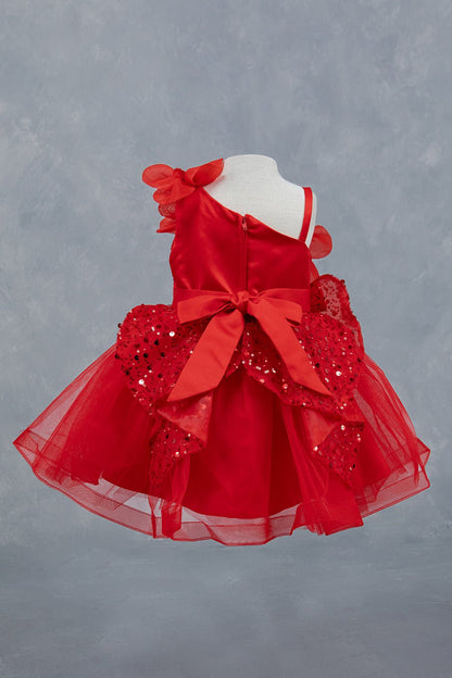 Red dress back view highlighting layered ruffles and elegant silhouette