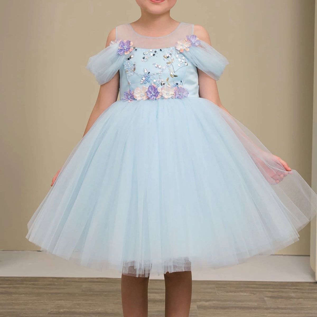 Light blue flower girl dress with floral embellishments.