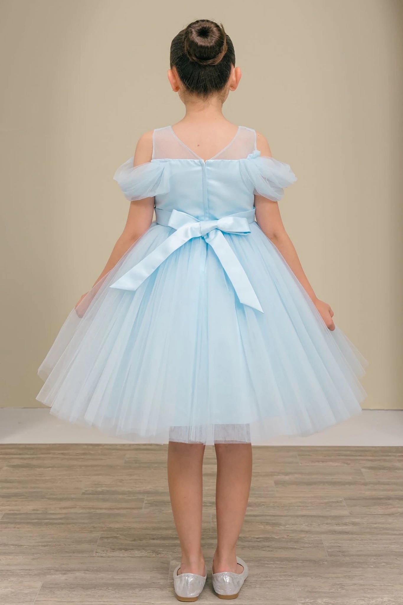Light blue tulle flower girl dress with a bow.