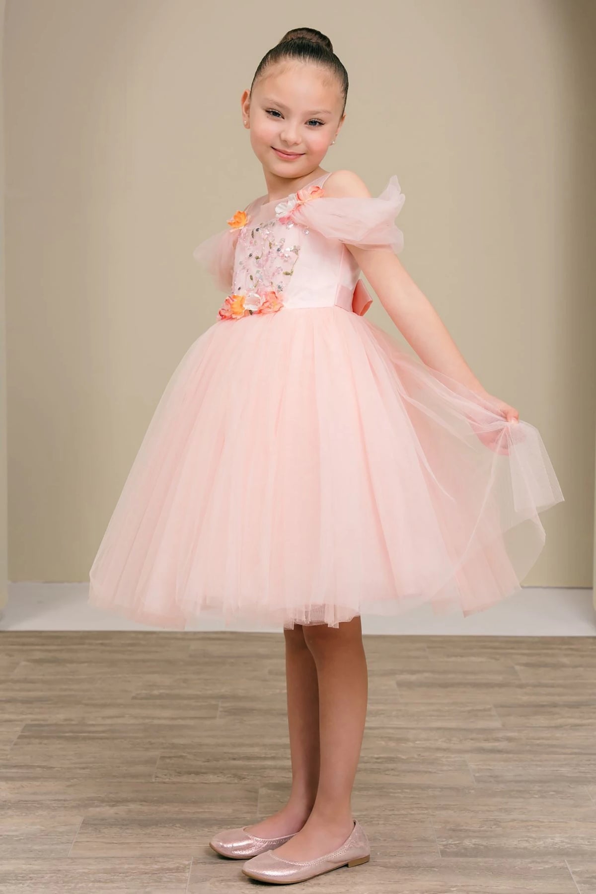 A pink flower girl dress with floral details.