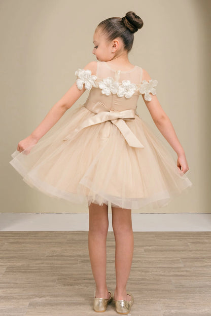 A Champagne flower girl dress showing back sash bow beneath the floral shoulder trim.