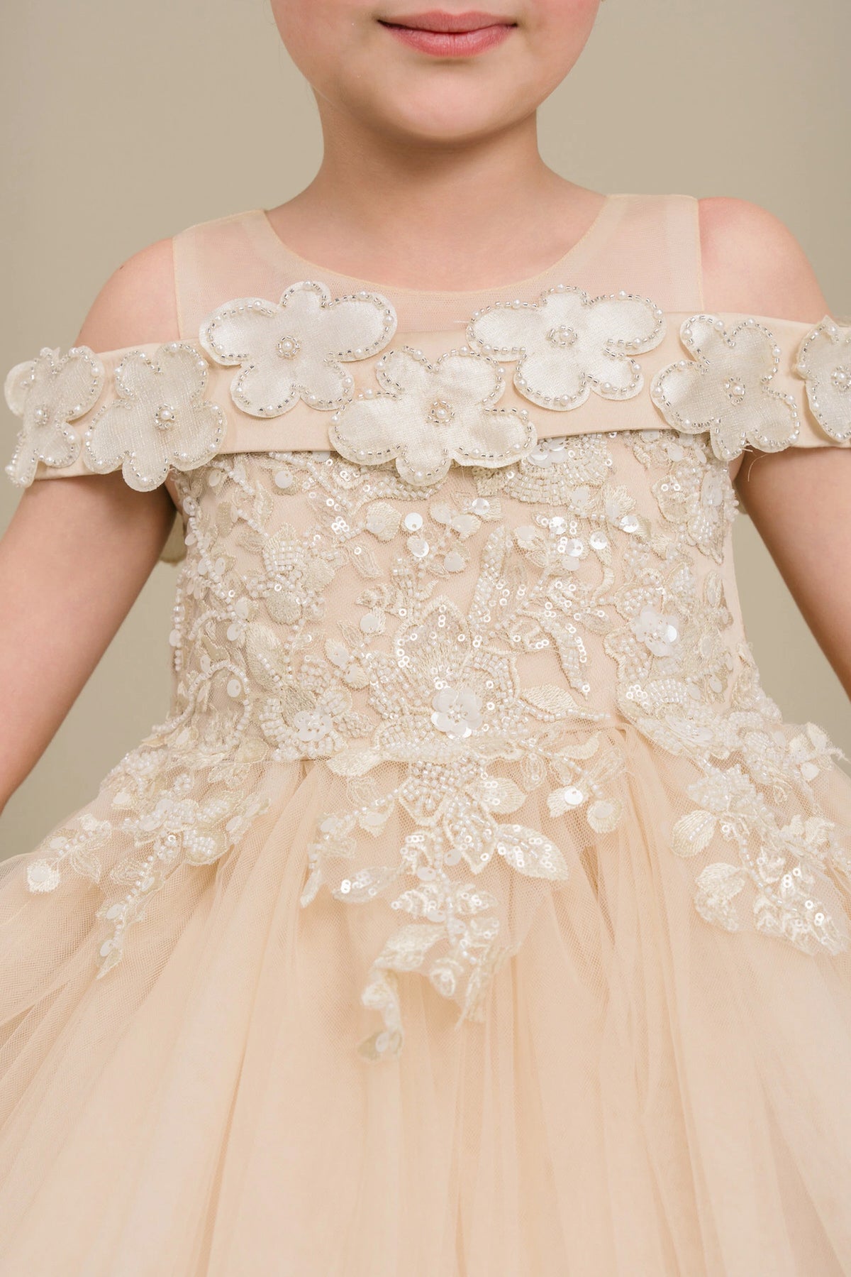 Visible on this Champagne flower girl dress: raised flowers along the neckline and waist.