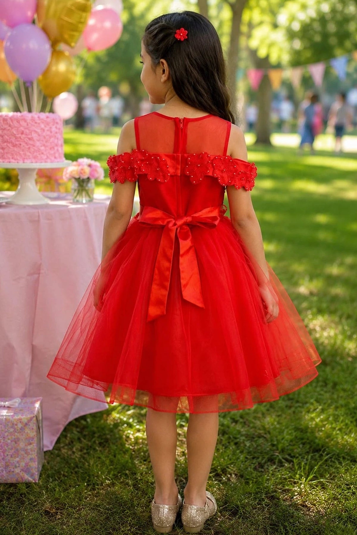 A Red flower girl dress showing satin bow below the sheer back yoke.