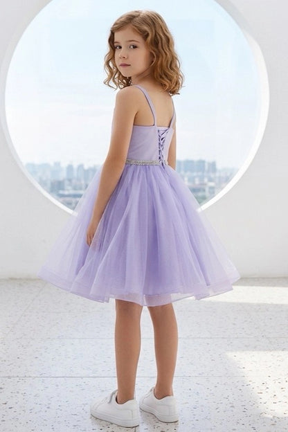 A Lilac flower girl dress showing lace-up back beneath crossed straps.