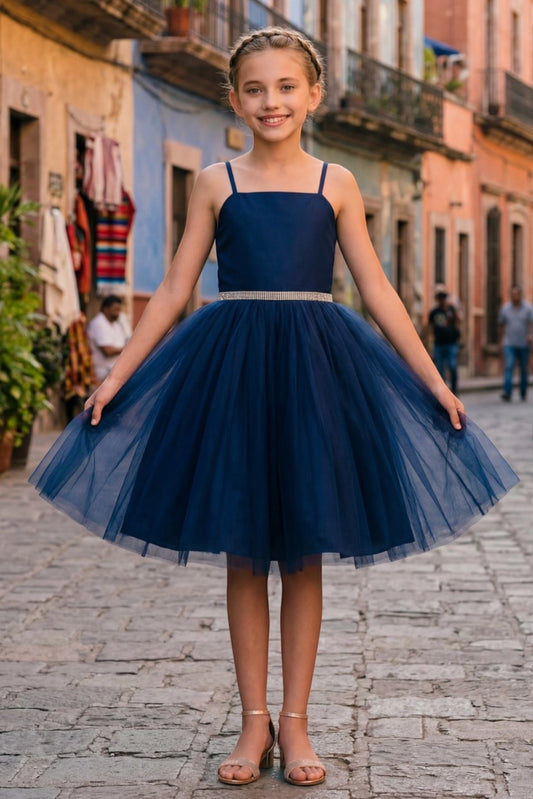 Navy flower girl dress features fitted satin bodice and layered tulle skirt.