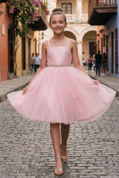 Pink flower girl dress features beaded waistband and layered tulle hem.