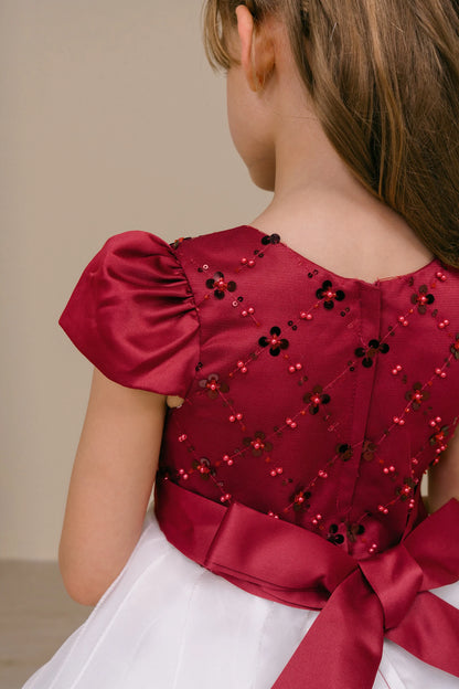 Gathered puff sleeves frame the embellished back of the Burgundy/Ivory kids party dress.