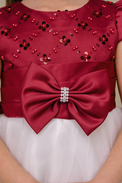 Floral sequins and a sparkling bow detail the Burgundy/Ivory kids party dress bodice.