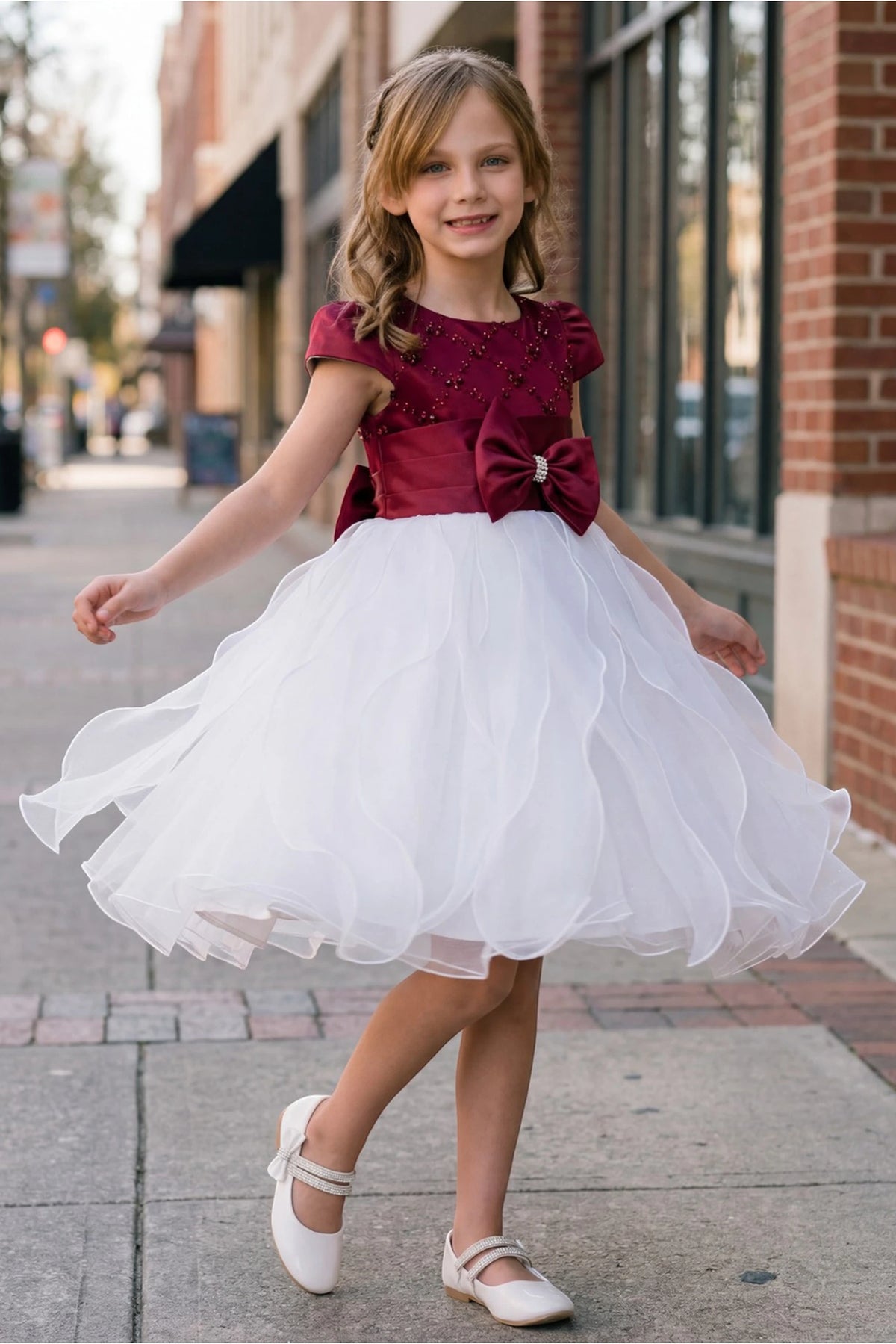 Burgundy/Ivory kids party dress with a jeweled waist bow and ruffled skirt.
