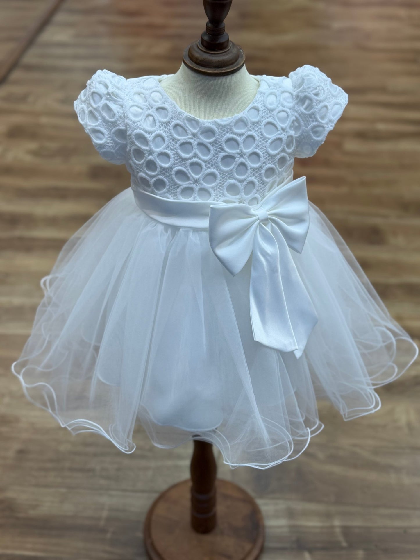 White flower girl dress front view with lace bodice puff sleeves and layered tulle skirt