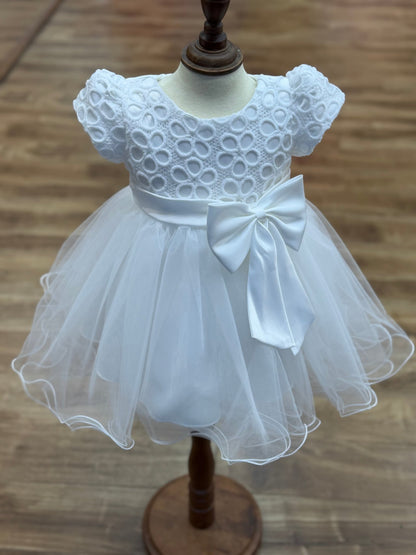 White flower girl dress front view with lace bodice puff sleeves and layered tulle skirt