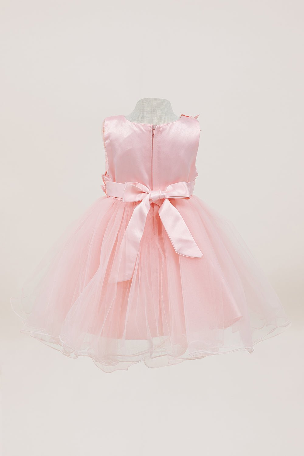Peach flower girl dress back view highlighting full skirt and elegant silhouette.