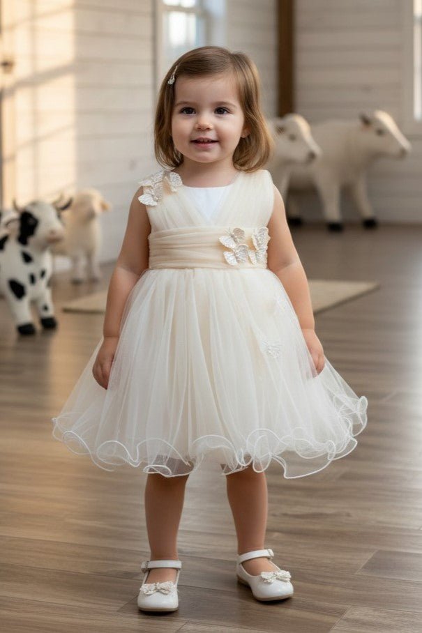Champagne flower girl Dress Front View With Layered Skirt And Oversized Bow Detail.