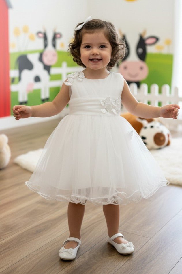 White flower girl Dress Front View With Layered Skirt And Oversized Bow Detail.