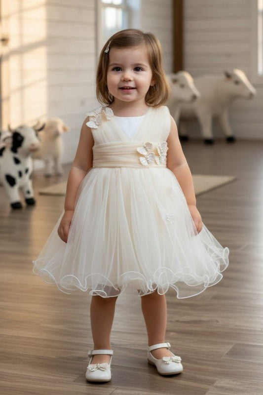 Kid Wearing Champagne Flower Girl Dress Front View With Layered Skirt And Oversized Bow Detail