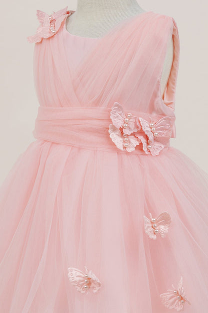 Close-up front view of peach dress showing shimmering fabric and bow accent