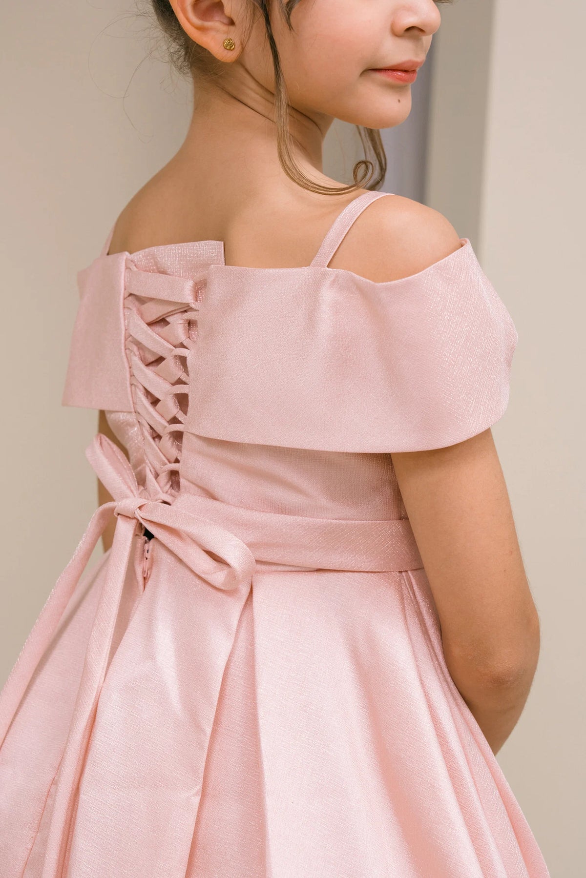 Finished details of back lacing and a waist sash distinguish the Blush kids party dress.