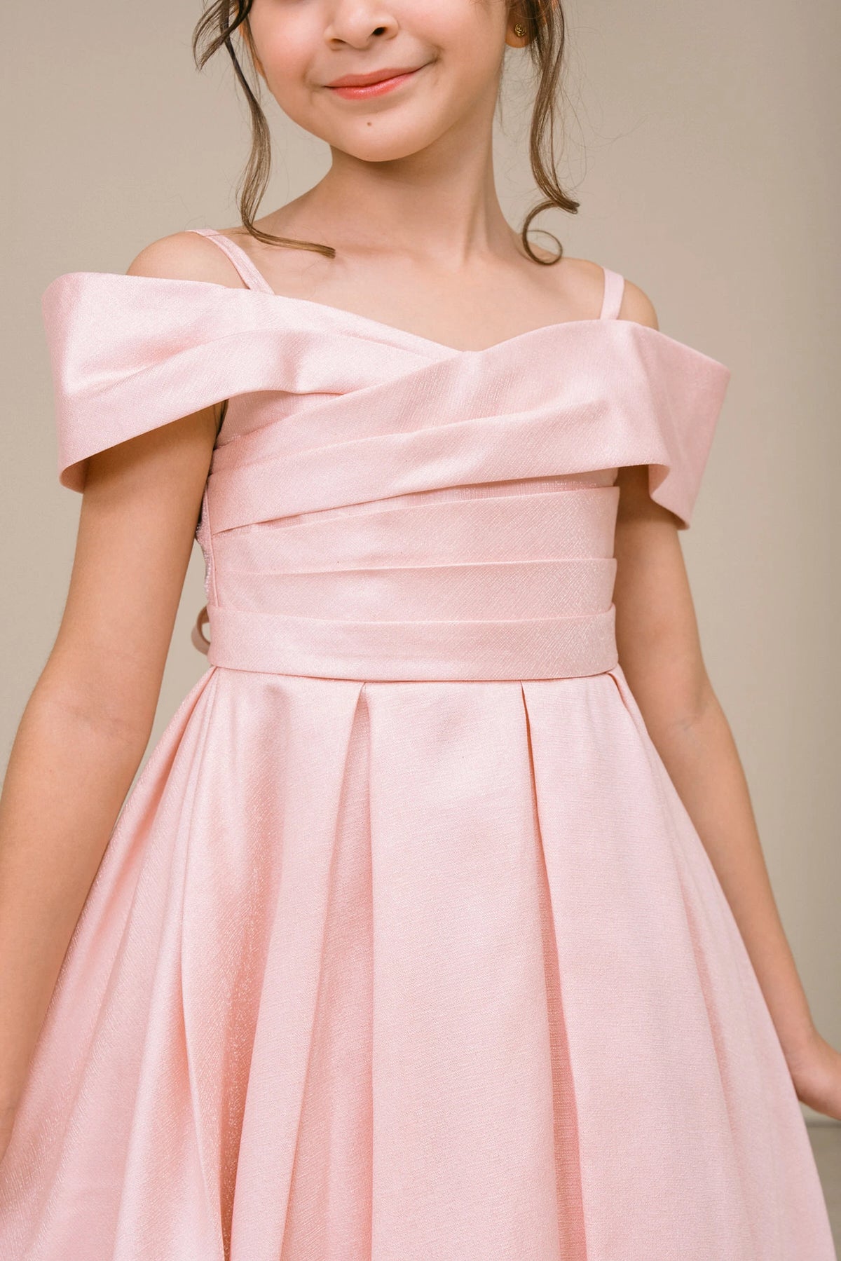 Accented a folded off-shoulder neckline adds character to this Blush kids party dress.