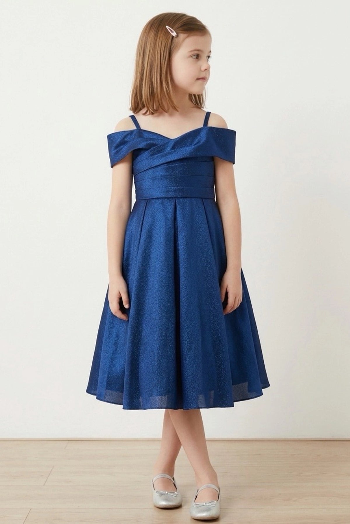 Showcasing with a folded off-shoulder neckline, this Navy kids party dress displays elegant detail.