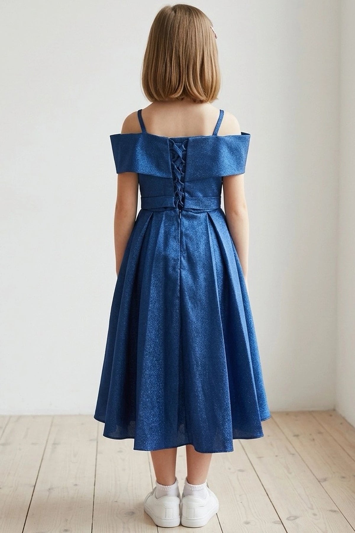 Finished details of back lacing and a waist sash distinguish the Navy kids party dress.