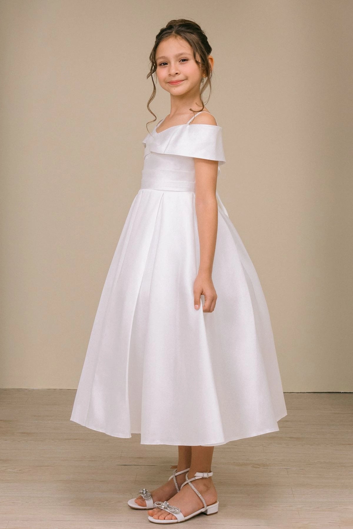 Designed details of a folded off-shoulder neckline distinguish the Off-White kids party dress.