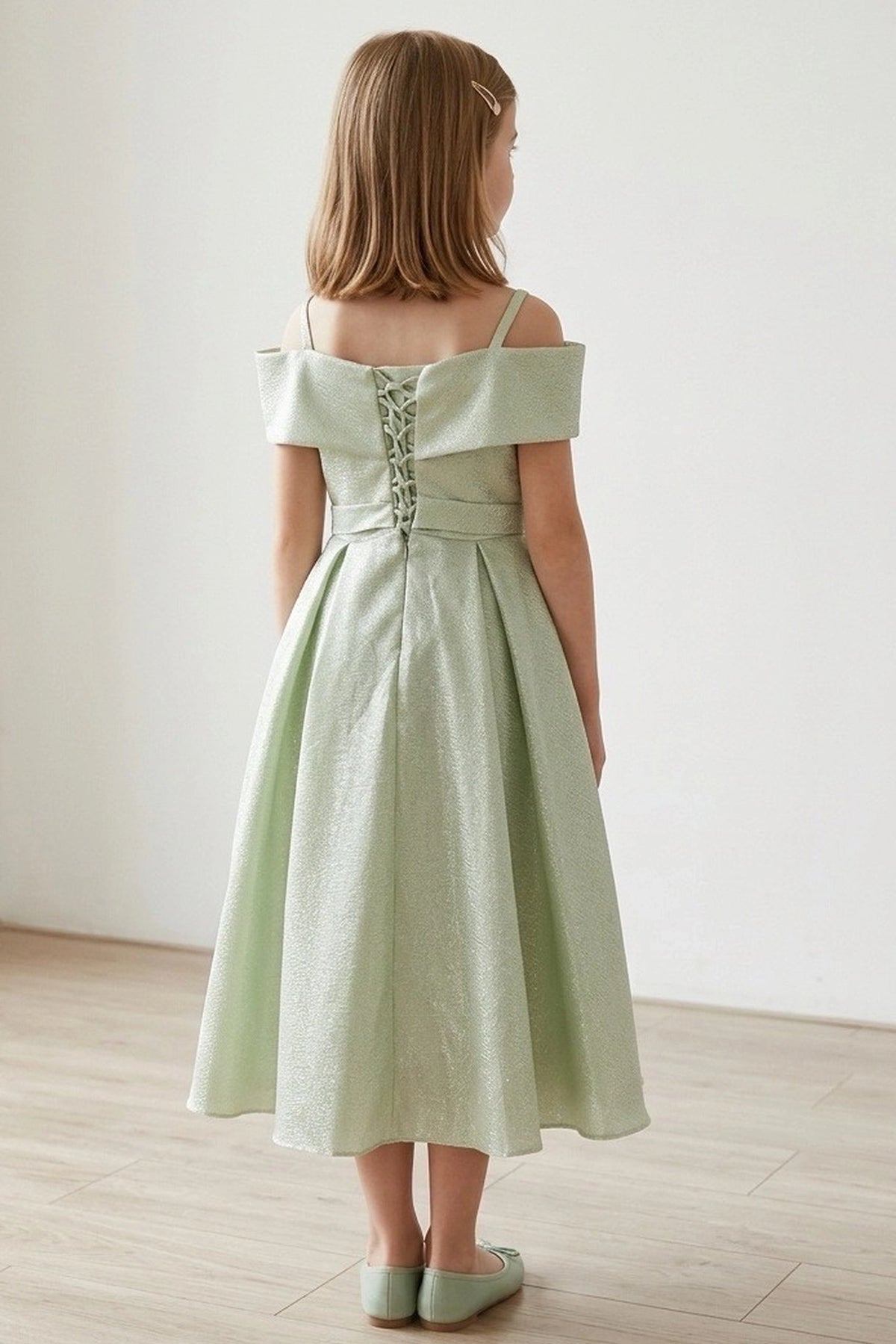 Finished details of back lacing and a waist sash distinguish the Sage kids party dress.