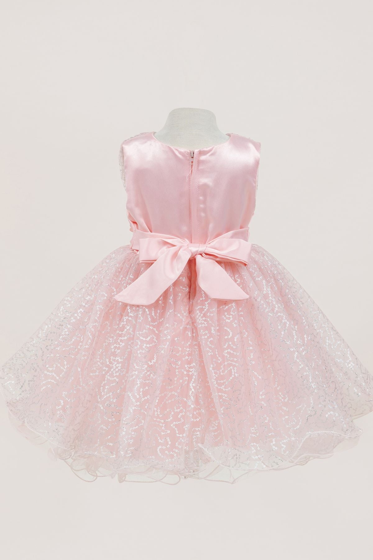 Peach flower girl dress back view highlighting full skirt and elegant silhouette.