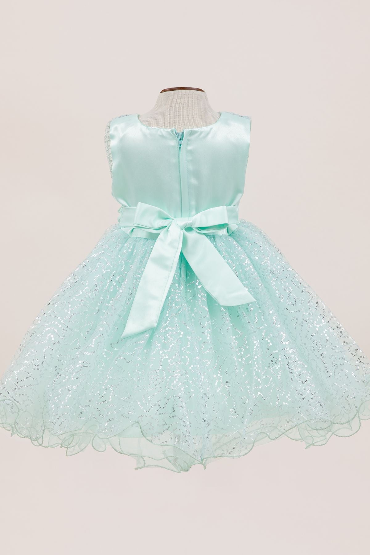 Mint flower girl dress back view highlighting full skirt and elegant silhouette.