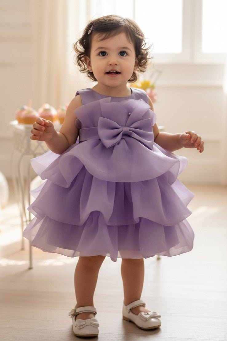 Lilac flower girl Dress Front View With Layered Skirt And Oversized Bow Detail.