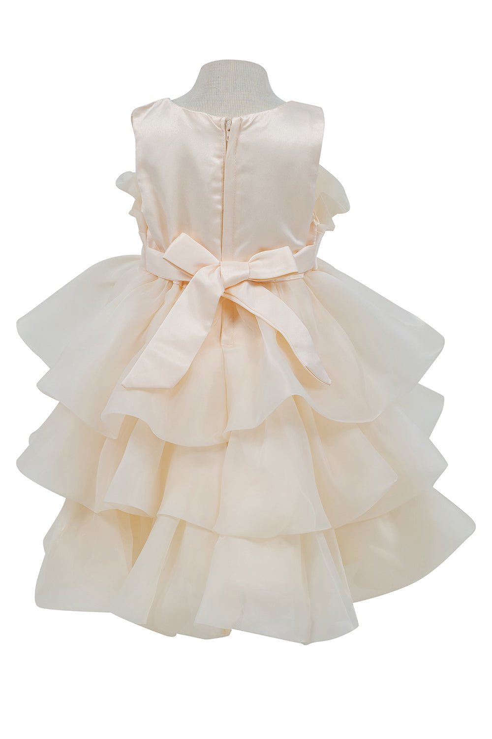 Champagne flower girl dress back view highlighting full skirt and elegant silhouette.