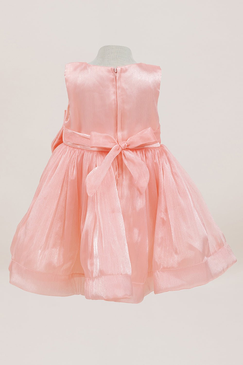 Pink flower girl dress back view highlighting full skirt and elegant silhouette.