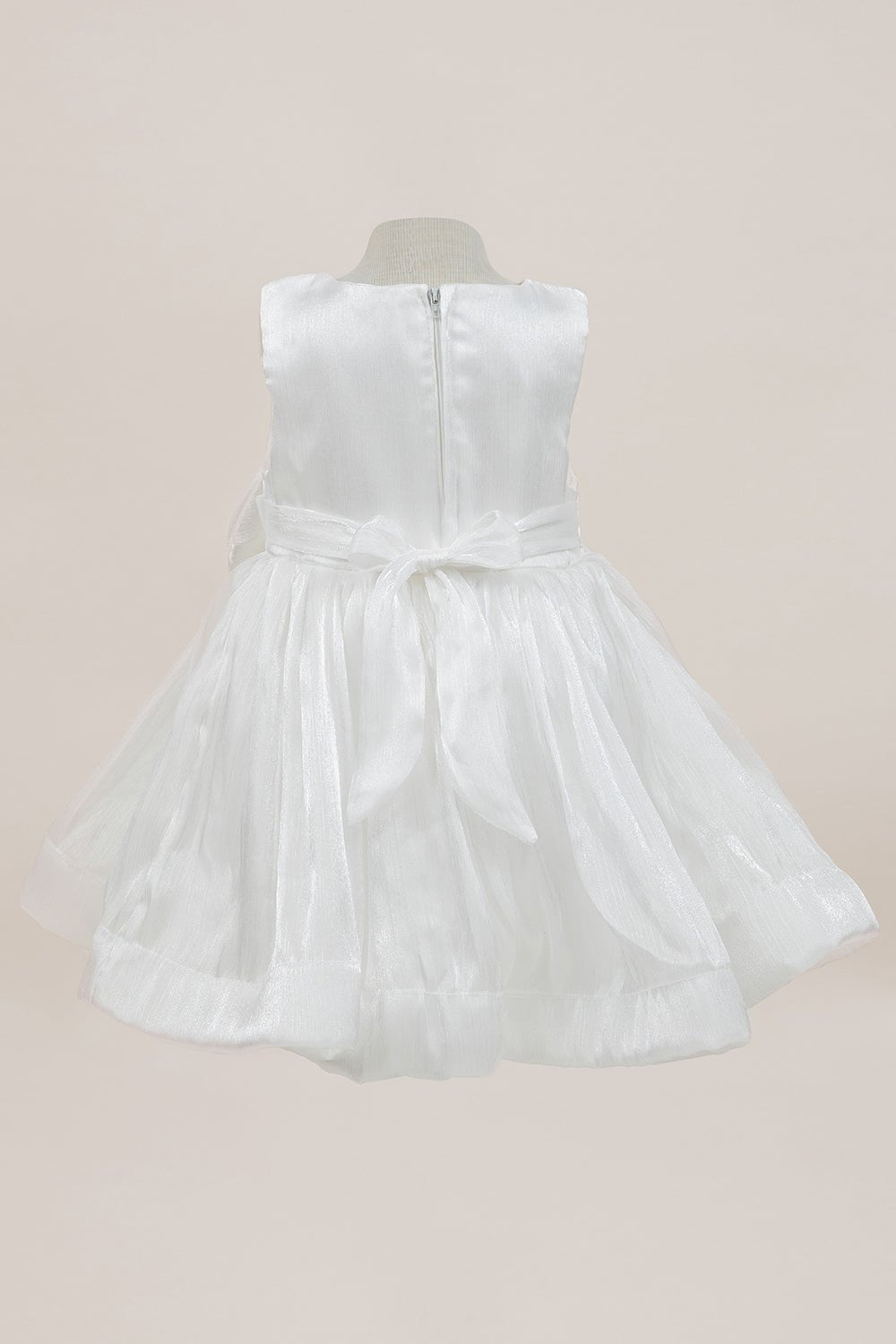 White flower girl dress back view highlighting full skirt and elegant silhouette.