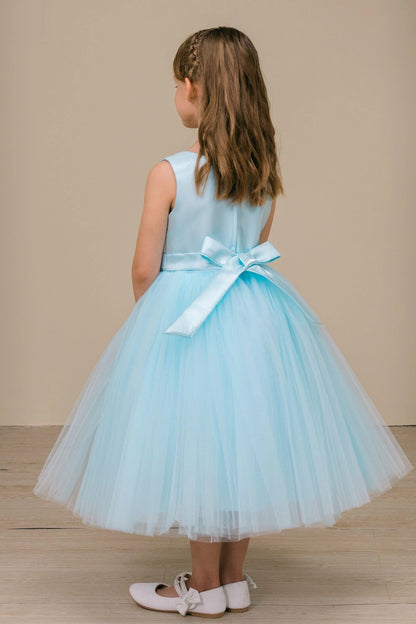 A Blue flower girl dress showing large satin bow above the tulle skirt.