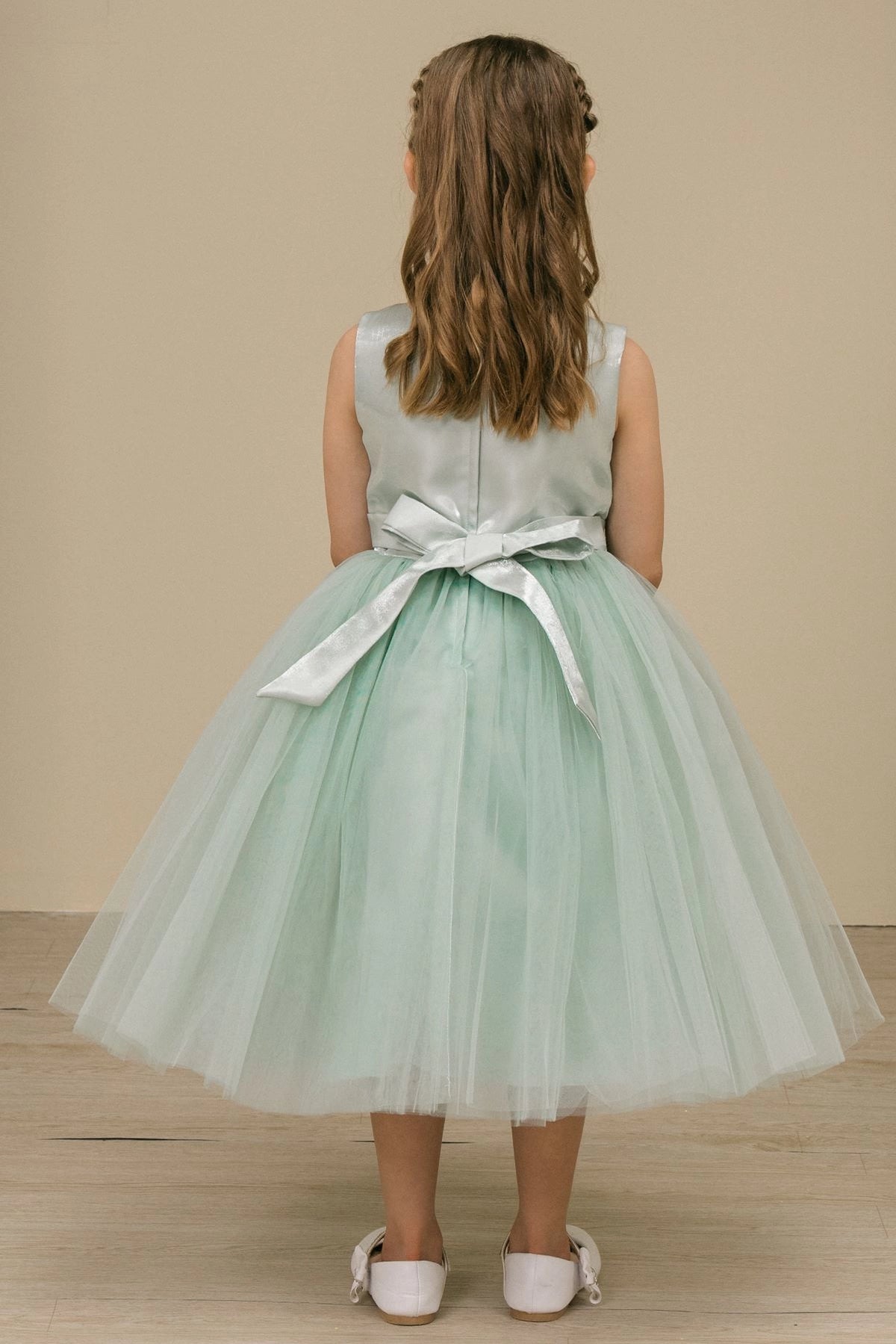 A Sage flower girl dress showing satin back bow below the sleeveless bodice.