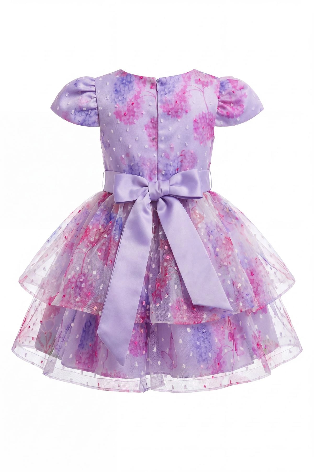Tied at the back, the Lilac kids dress features a large bow.