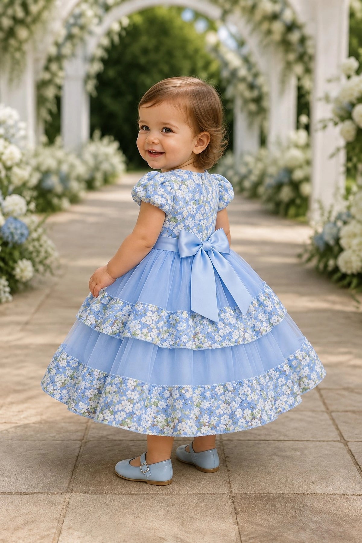 Tied at the back, the Blue kids dress features a large bow.
